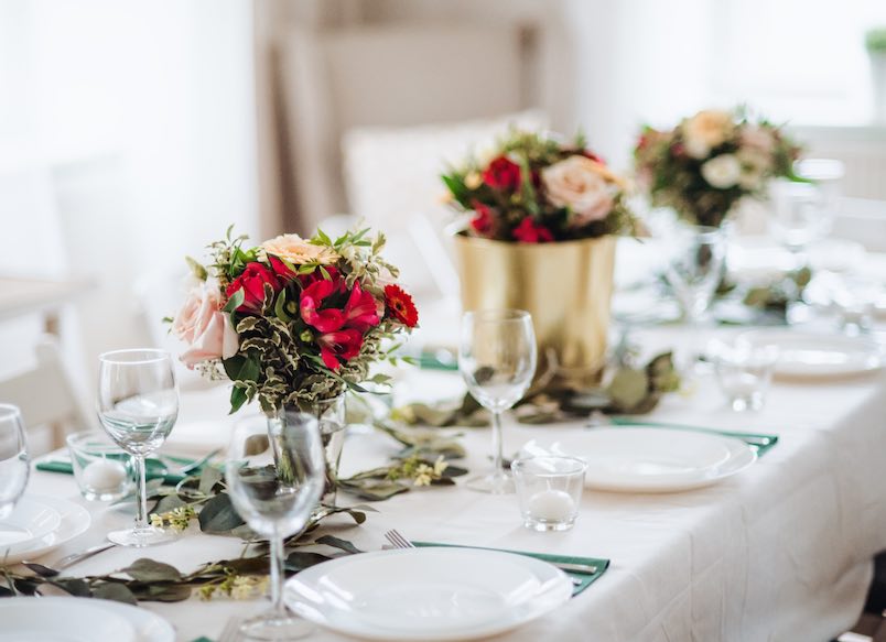 Table set for a meal indoors in a room on a party, a wedding or family celebration.