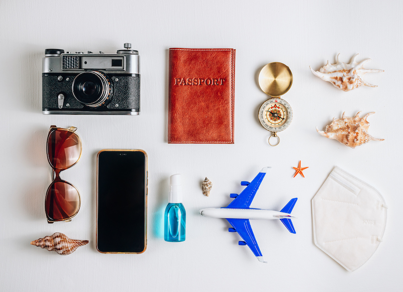 Time to travel concept, camera, passport, money, phone with empty screen, sunglasses and and compass on white background.