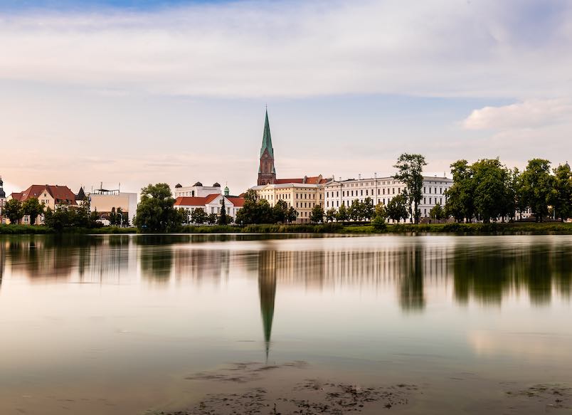 Cityscape of historic centre of Schwerin and Burgsee lake, Germany. Long exposure